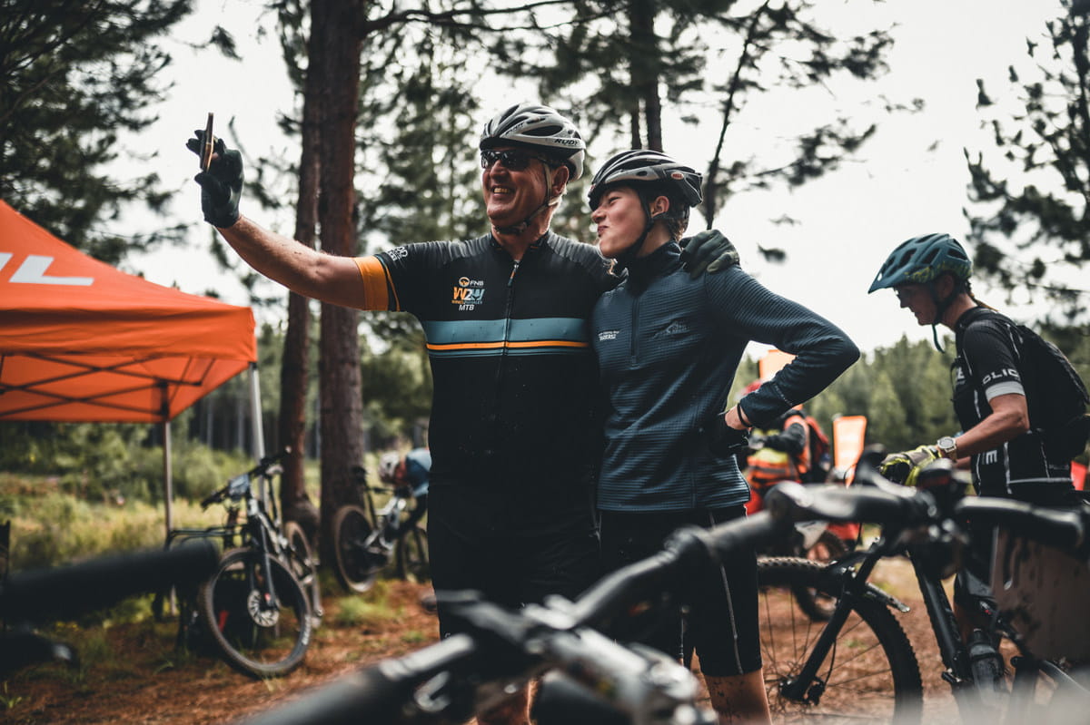 Johan Bouwer stopping for a selfie with his daughter Anna, who rode her first stage race at the Glacier Storms River Traverse. Photo by Justin Reinecke for zcmc.co.za. 