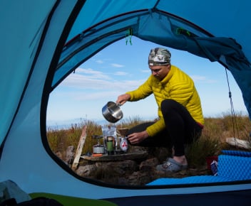 1 person looking at the mountain views with his First Ascent hiking tent