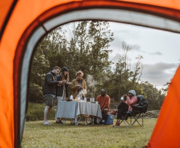 Friends pitching a First Ascent hiking tent