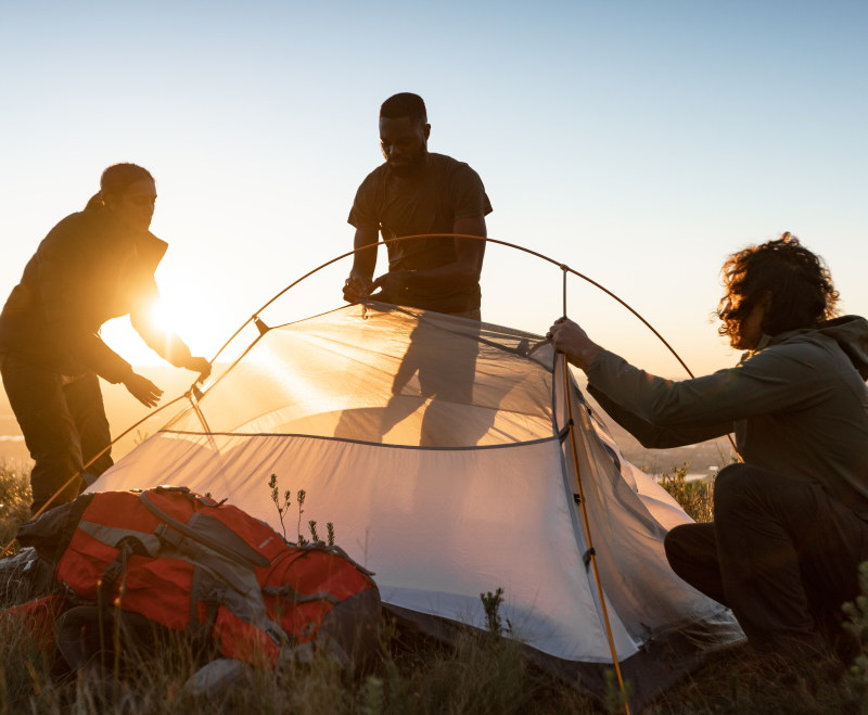 Friends pitching a First Ascent hiking tent
