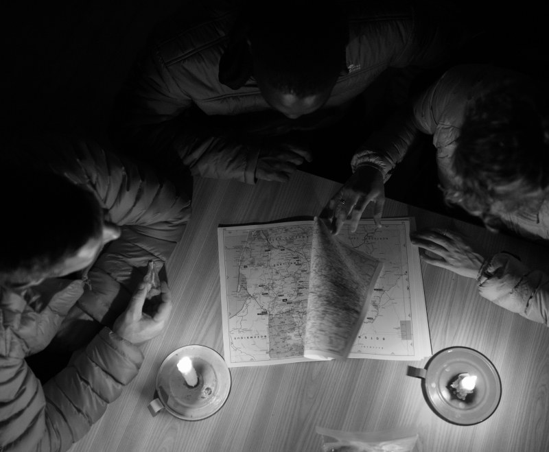 First Ascent Explore Page Friends looking at a map before they go on adventure
