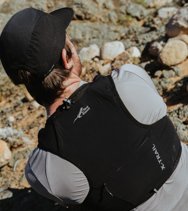 Lady running in First Ascent Limitless Cap and X-Trail tee in slippery stone 